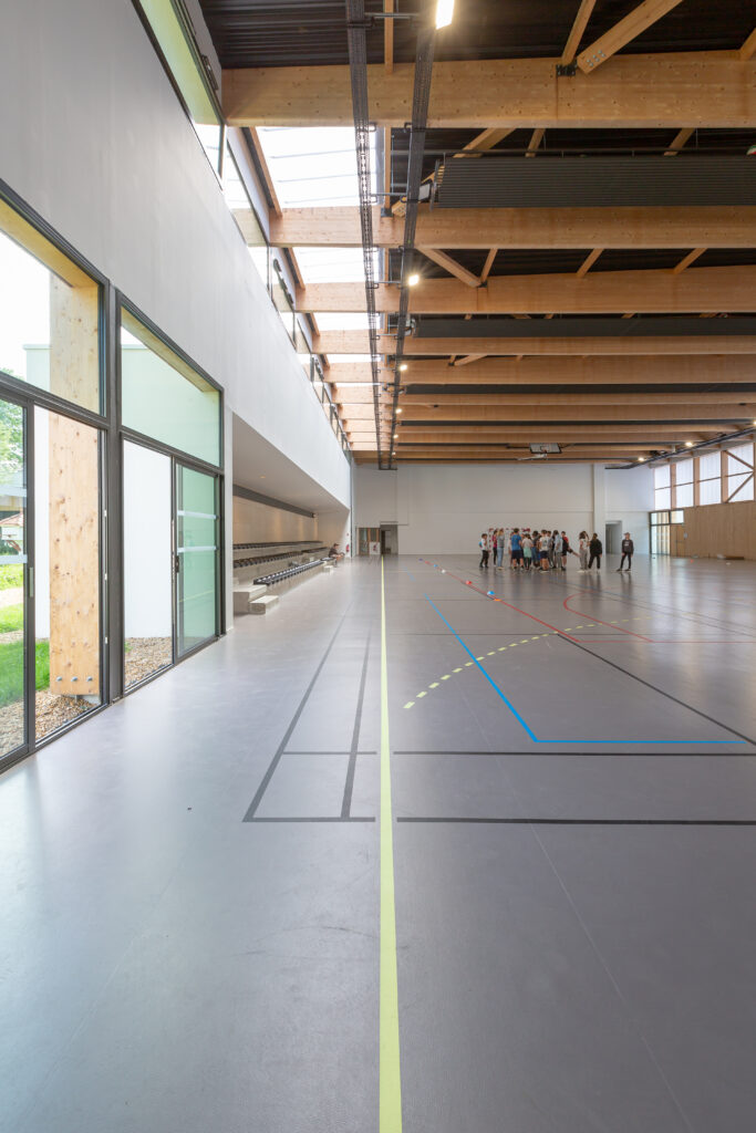 Salle multisports du groupe scolaire Largenté à Bayonne offrant un vaste espace sportif éclairé naturellement.