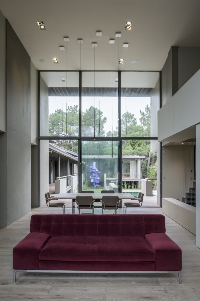 Salon lumineux d'une villa contemporaine avec grandes baies vitrées.